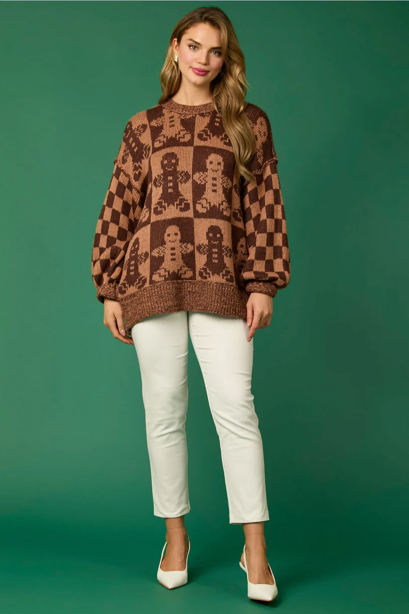 Pull tricoté avec des épingles de Noël en forme de canne à sucre et un bonhomme en pain d'épices