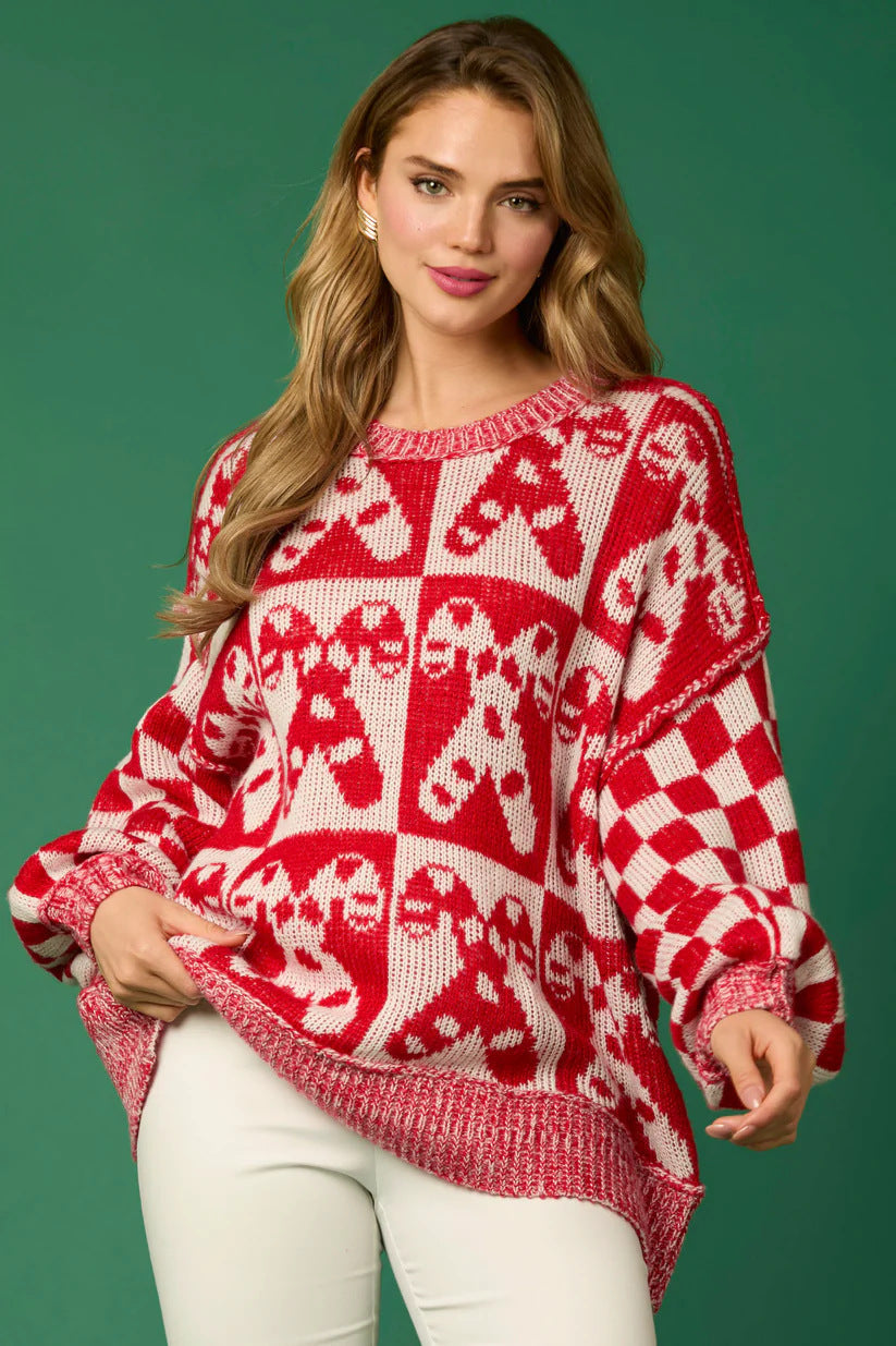 Pull tricoté avec des épingles de Noël en forme de canne à sucre et un bonhomme en pain d'épices